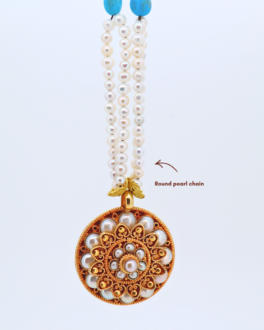 Pearl necklace with a decorative pendant on a white background