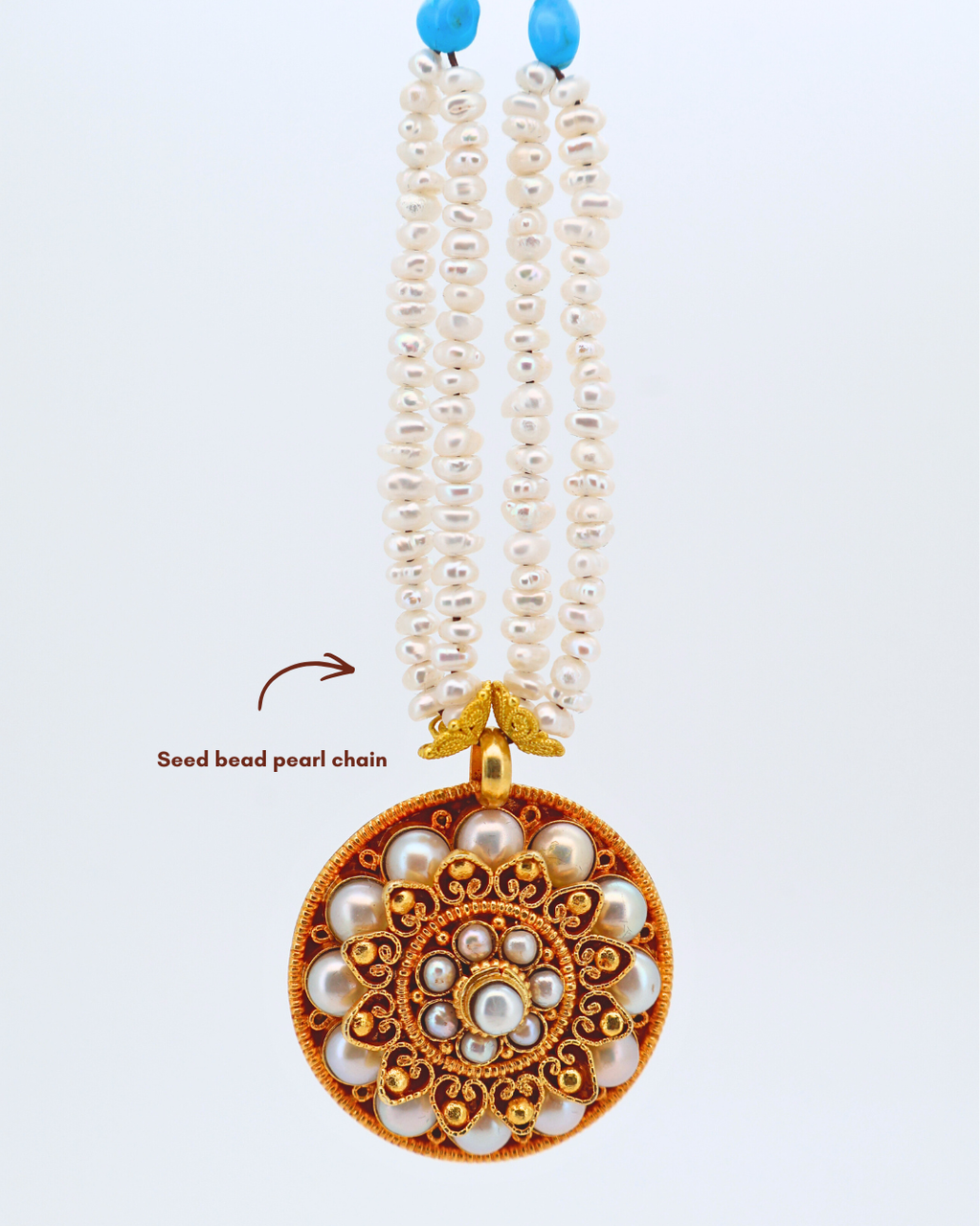 Pearl necklace with a decorative pendant on a white background