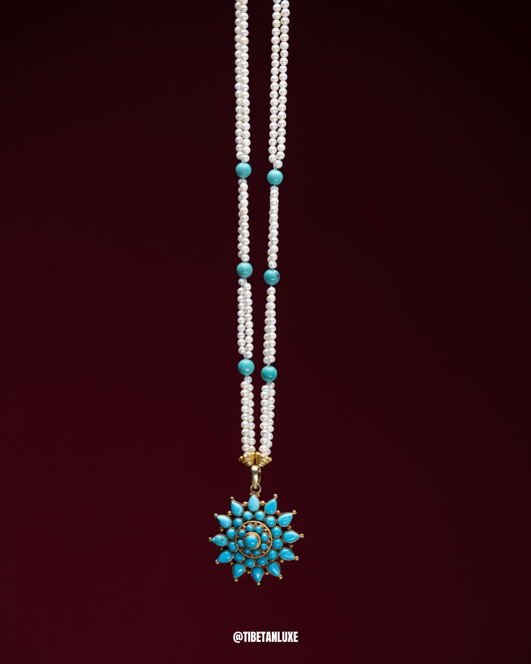 Necklace with white beads and turquoise stones on a dark red background