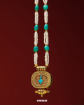 Gold necklace with turquoise beads on a red background