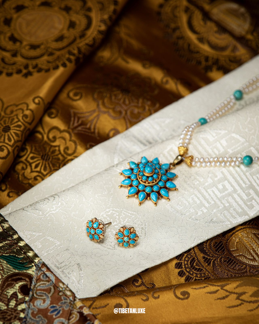 Jewelry set with turquoise stones on a white fabric background